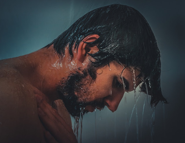 sad man in shower