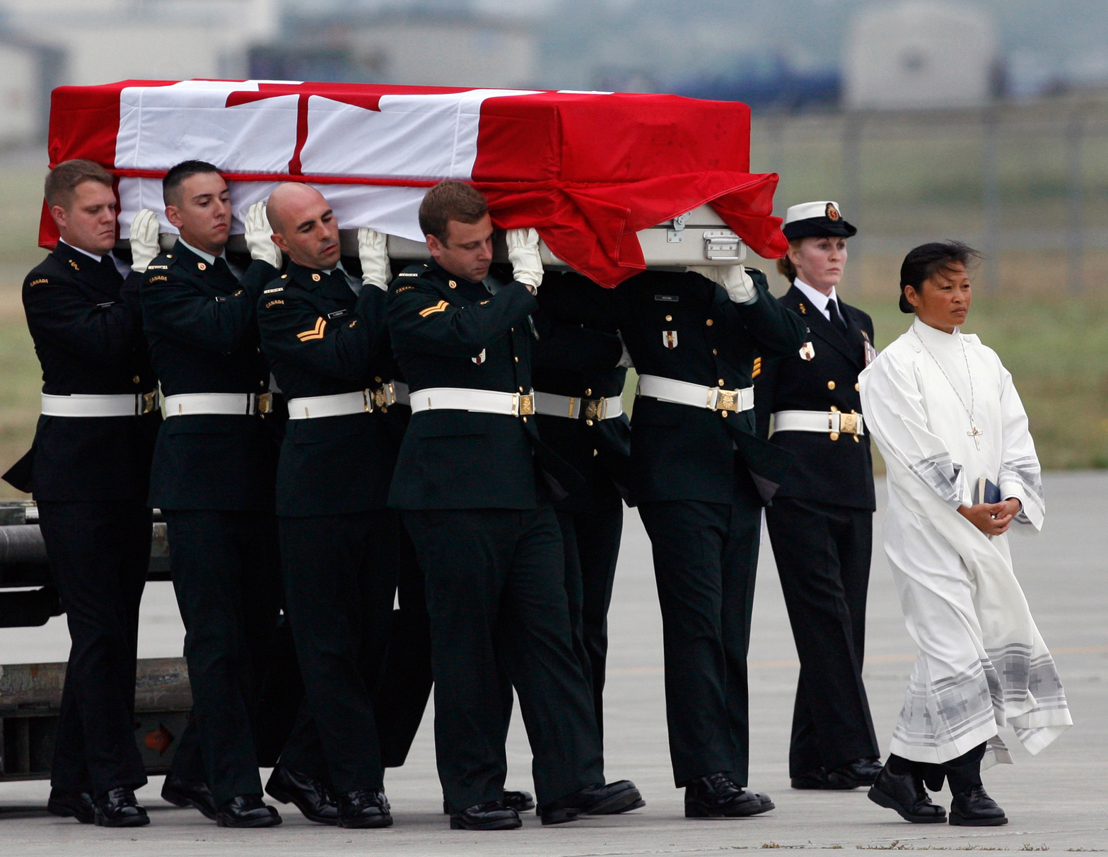 Pallbearers carry the casket of Corporal Andrew James Eykelenboom at CFB Trenton